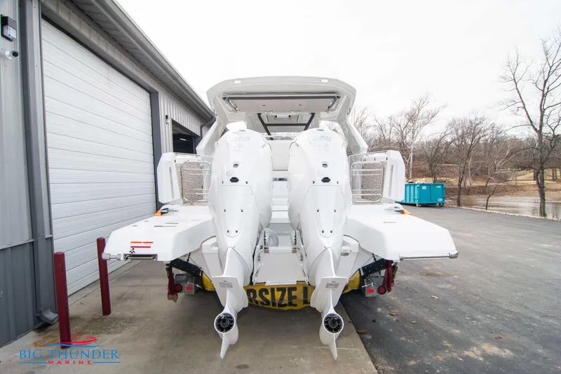 Slide: The Image of 2024 Jeanneau DB/37 OB boat with twin outboard engines at a marina. - 8