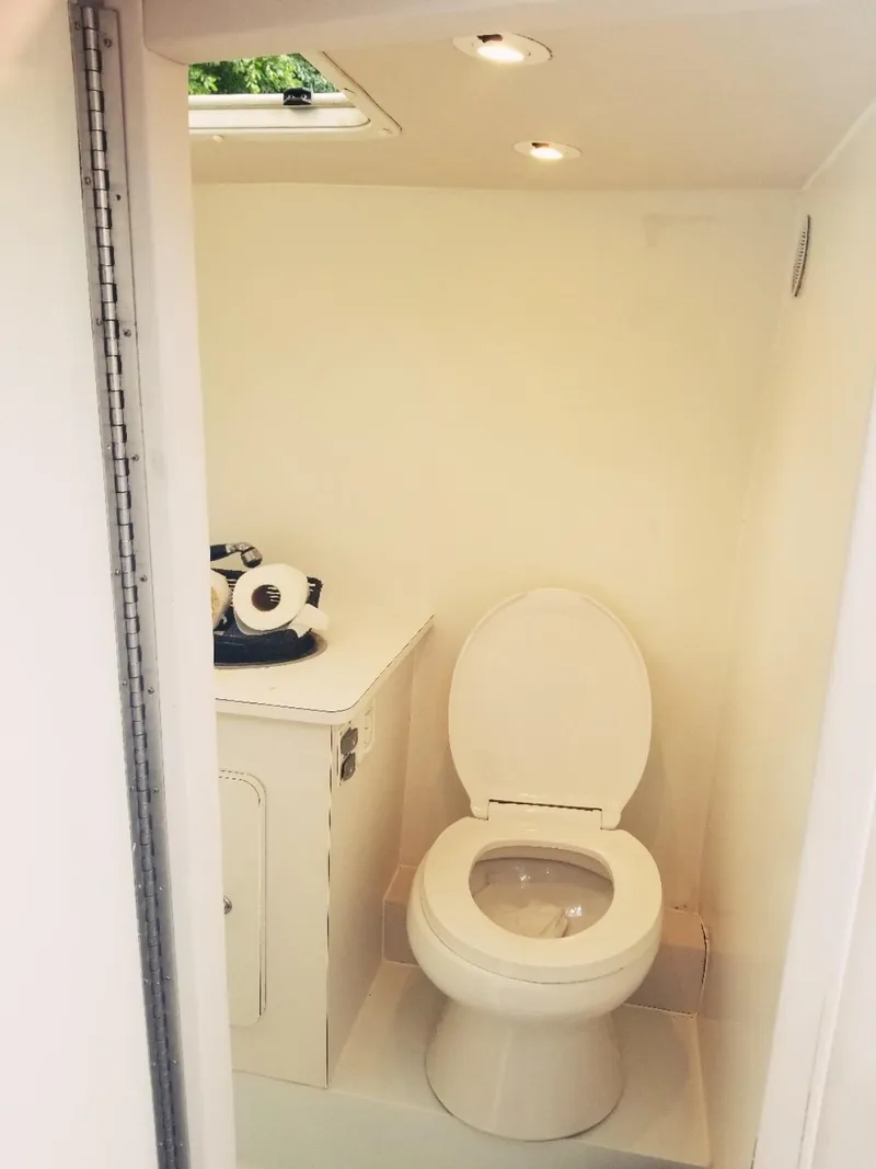 Slide: The Image of 1985 Wellcraft Excalibur Eagle 42 boat bathroom with toilet and storage cabinet. - 2