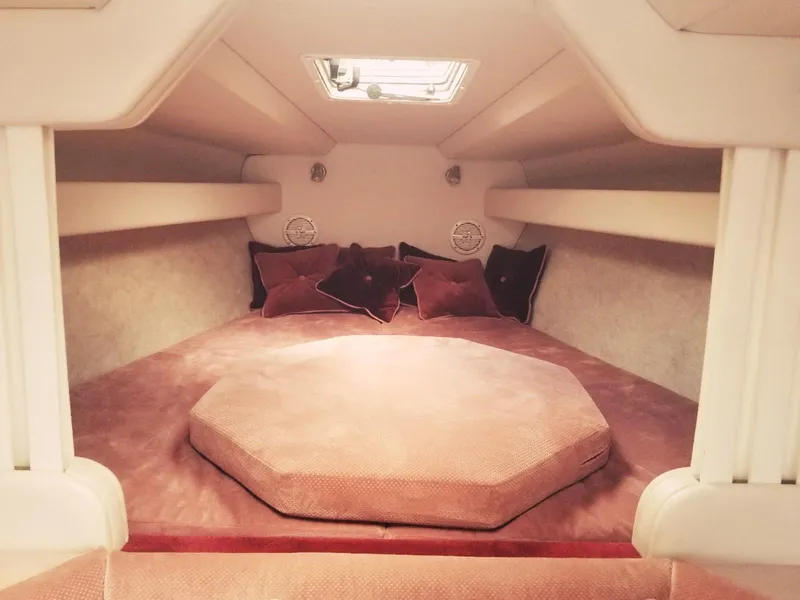 Slide: The Image of 1985 Wellcraft Excalibur Eagle 42 cabin interior with plush bedding and cushions. - 4