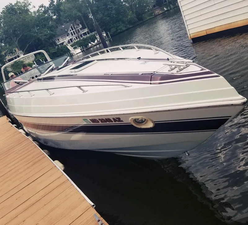 Slide: The Image of 1985 Wellcraft Excalibur Eagle 42 docked on a calm lake. - 9