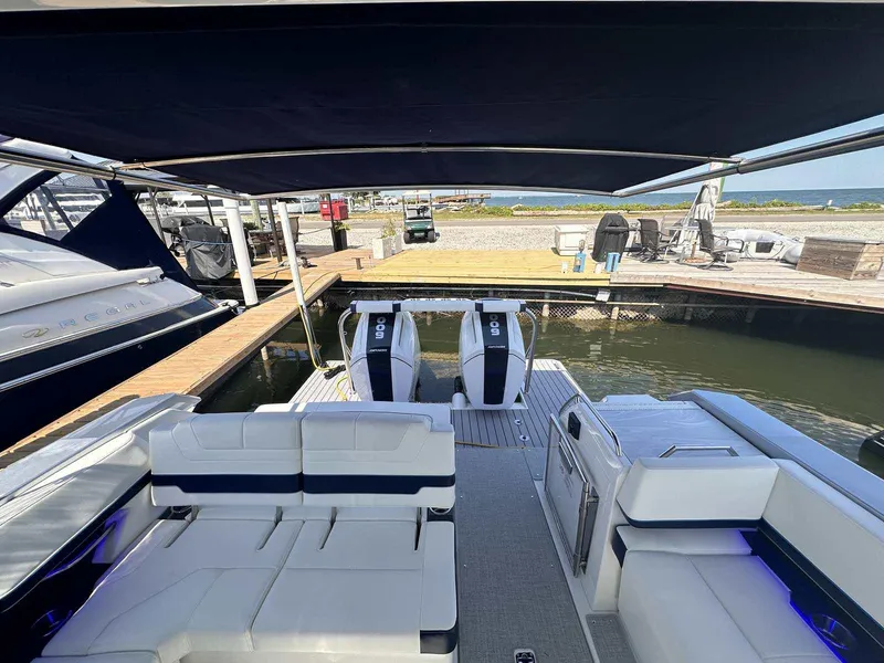 Slide: The Image of 2025 Formula 380 Super Sport Crossover OB at dock, featuring spacious seating and dual outboard engines. - 14