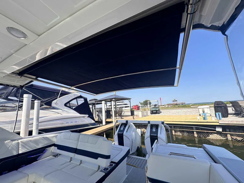 Slide: The Image of 2025 Formula 380 Super Sport Crossover OB at dock, featuring spacious seating and sunshade. - 15