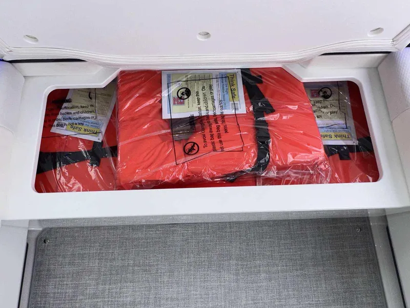 Slide: The Image of Life jackets stored in a compartment on a 2025 Formula 380 Super Sport Crossover OB. - 18