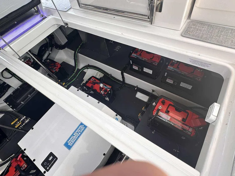 Slide: The Image of 2025 Formula 380 Super Sport Crossover OB battery compartment with multiple batteries and wiring. - 21