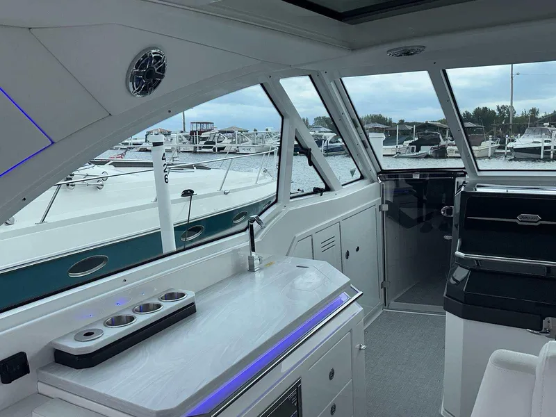 Slide: The Image of Interior of 2025 Formula 380 Super Sport Crossover OB, featuring sleek design and marina view. - 25