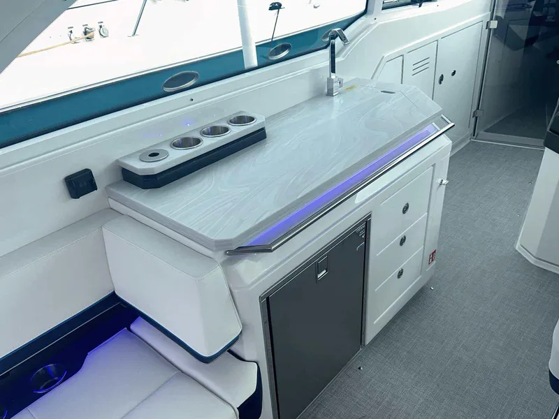 Slide: The Image of 2025 Formula 380 Super Sport Crossover OB interior with sleek kitchenette and modern design. - 26