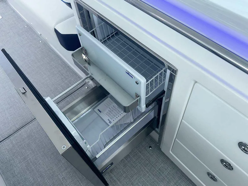 Slide: The Image of 2025 Formula 380 Super Sport Crossover OB boat interior with open drawer and storage. - 28
