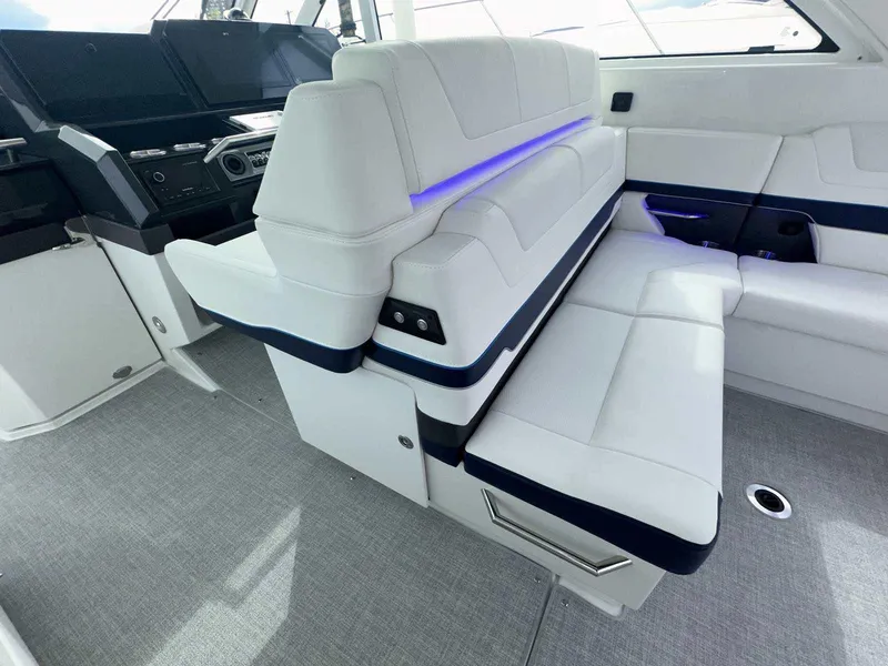 Slide: The Image of 2025 Formula 380 Super Sport Crossover OB interior with white seating and modern dashboard. - 30