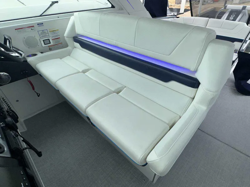 Slide: The Image of 2025 Formula 380 Super Sport Crossover OB interior with white seating and blue accent lighting. - 35