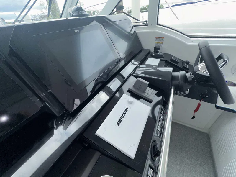 Slide: The Image of 2025 Formula 380 Super Sport Crossover OB helm with Mercury controls and modern dashboard. - 38