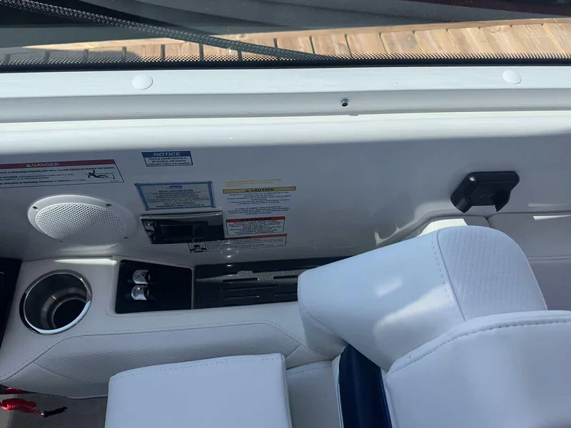 Slide: The Image of Interior view of 2025 Formula 380 Super Sport Crossover OB boat, featuring white seating and control panel. - 42