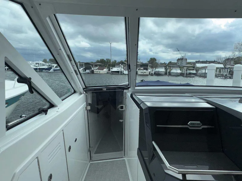 Slide: The Image of Interior view of 2025 Formula 380 Super Sport Crossover OB boat at marina. - 47