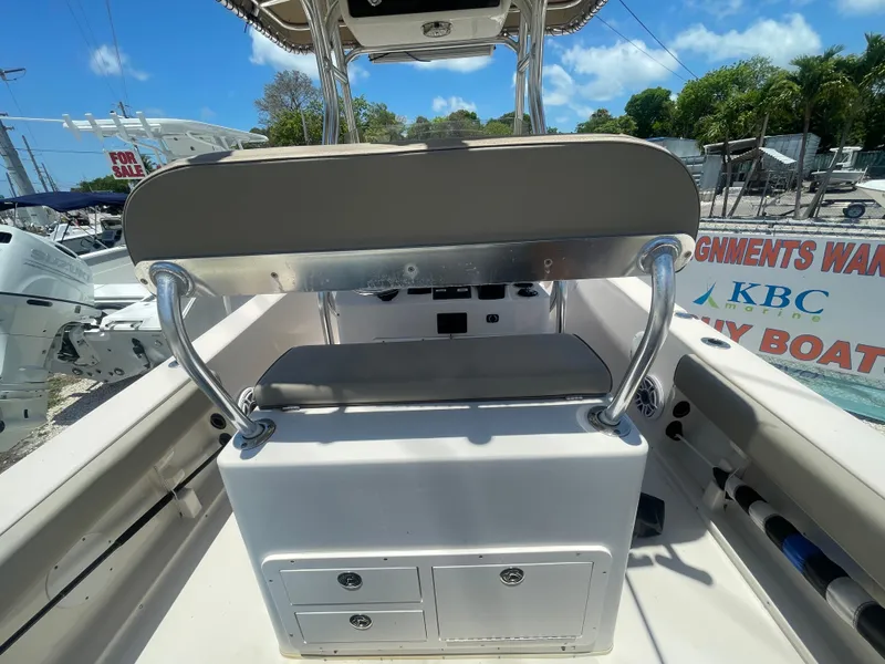 Slide: The Image of 2006 Cobia 254 Center Console boat interior with storage compartments and seating. - 5