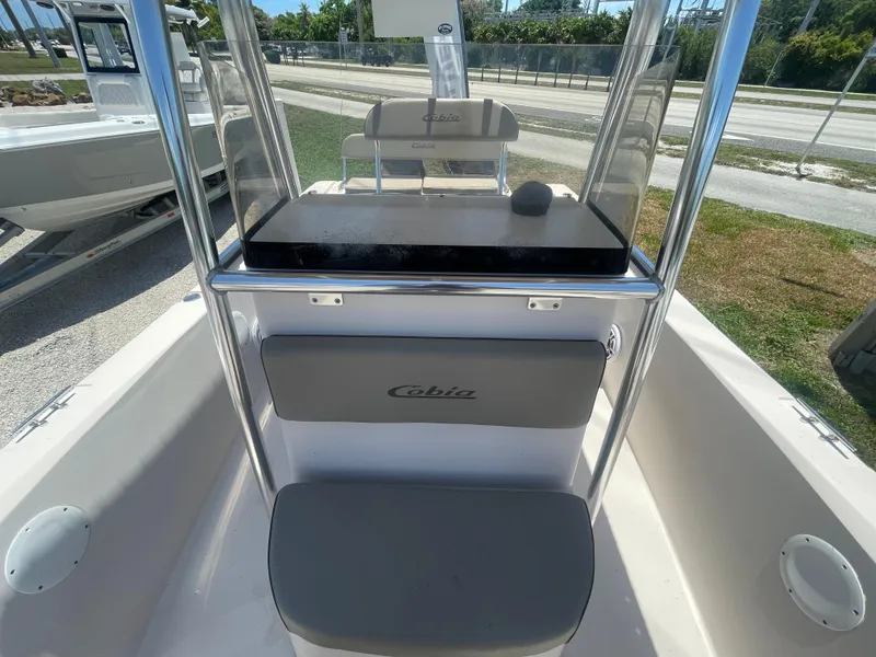 Slide: The Image of 2006 Cobia 254 Center Console boat interior with seating and console. - 8