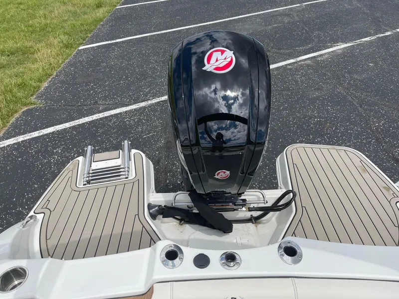 Slide: The Image of 2024 Stingray 182 SC boat with outboard motor and swim platform. - 13