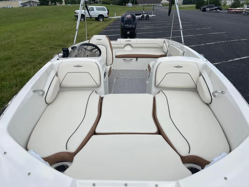 Slide: The Image of 2024 Stingray 182 SC boat interior with white and brown seating. - 4