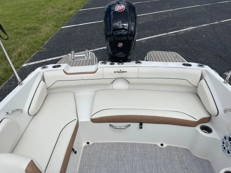 Slide: The Image of 2024 Stingray 182 SC boat with spacious seating and outboard motor. - 5