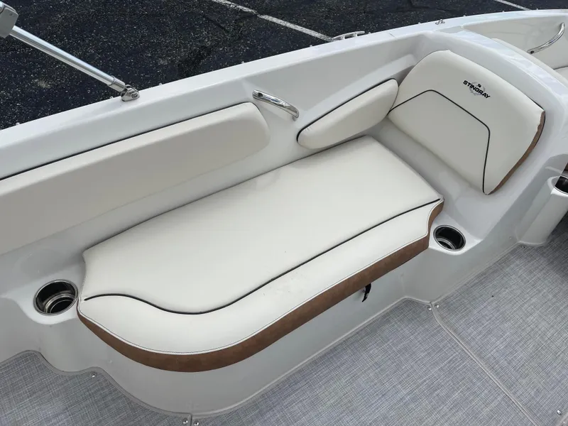 Slide: The Image of 2024 Stingray 182 SC boat with white and brown cushioned seating. - 9