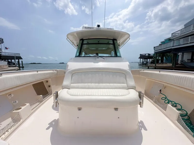 Slide: The Image of 2011 Grady-White 366 Canyon boat with 2020 Suzuki engines, docked by the water. - 13