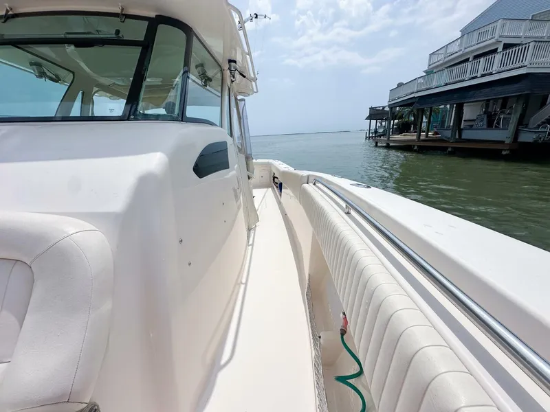 Slide: The Image of Grady-White 366 Canyon boat with 2020 Suzuki engines docked by waterfront homes. - 14