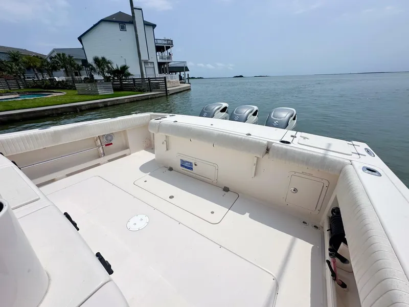 Slide: The Image of Grady-White 366 Canyon boat with 2020 Suzuki engines docked by waterfront homes. - 16