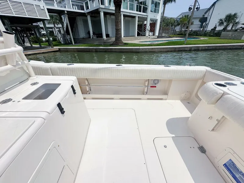 Slide: The Image of Grady-White 366 Canyon 2011 boat deck with 2020 Suzuki engines, docked by waterfront homes. - 18