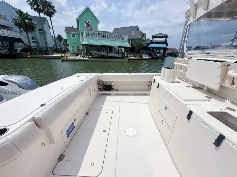 Slide: The Image of Grady-White 366 Canyon boat with 2020 Suzuki engines, docked near waterfront homes. - 19