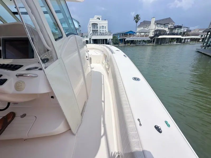 Slide: The Image of 2011 Grady-White 366 Canyon boat with 2020 Suzuki engines docked near waterfront homes. - 20