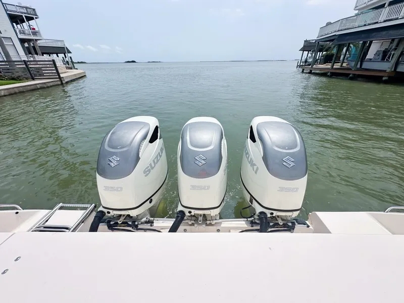 Slide: The Image of Grady-White 366 Canyon with 2020 Suzuki engines, docked by waterfront homes. - 21