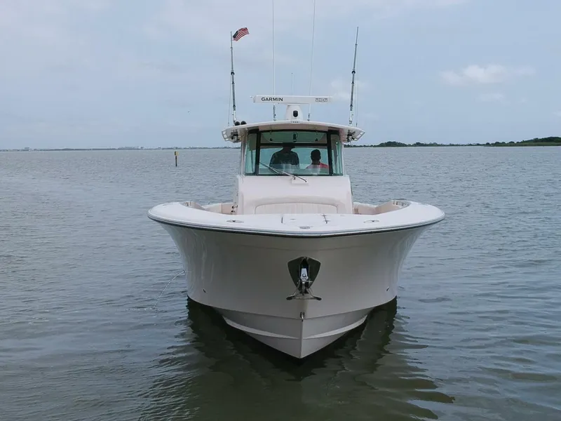 Slide: The Image of Grady-White 366 Canyon boat with 2020 Suzuki engines on calm water, front view. - 24