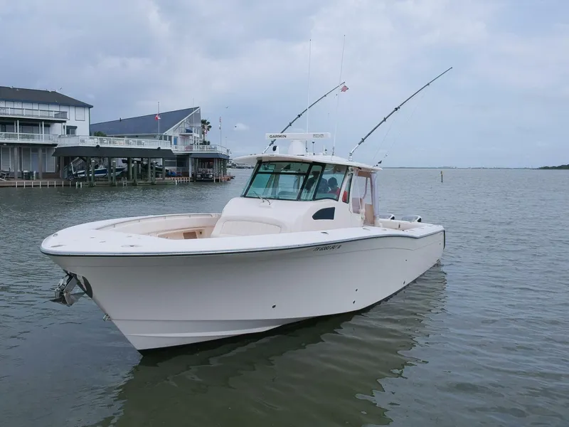 Slide: The Image of Grady-White 366 Canyon boat with 2020 Suzuki engines docked in a marina, 2011 model. - 25