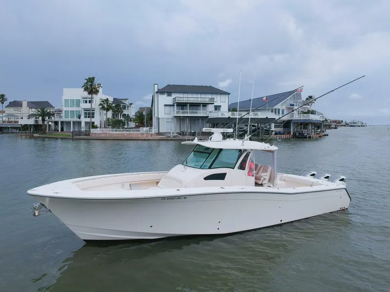 Slide: The Image of 2011 Grady-White 366 Canyon boat with 2020 Suzuki engines on calm water. - 26