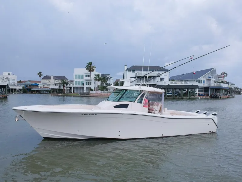 Slide: The Image of 2011 Grady-White 366 Canyon boat with 2020 Suzuki engines on the water. - 28