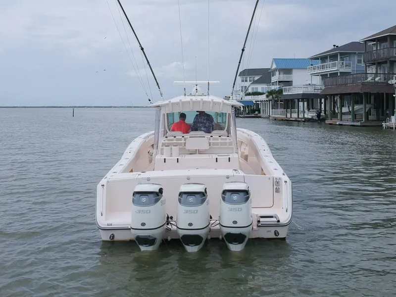 Slide: The Image of Grady-White 366 Canyon boat with 2020 Suzuki engines, docked near waterfront homes. - 32