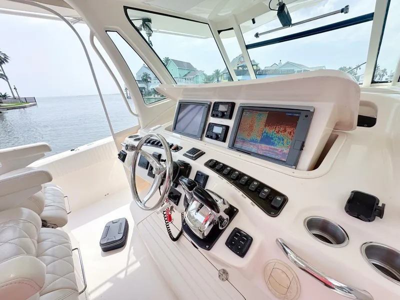 Slide: The Image of Helm of 2011 Grady-White 366 Canyon with 2020 Suzuki engines, featuring advanced navigation systems. - 5
