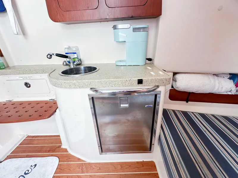 Slide: The Image of Compact kitchenette in 2011 Grady-White 366 Canyon boat with sink, mini-fridge, and coffee maker. - 8