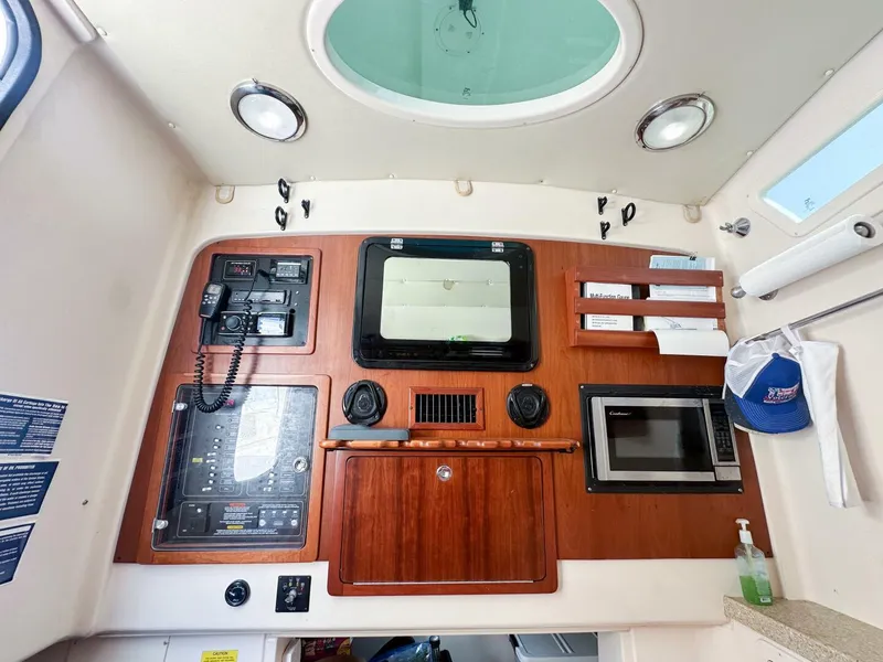 Slide: The Image of Grady-White 366 Canyon 2011 interior with control panel, microwave, and storage. - 9