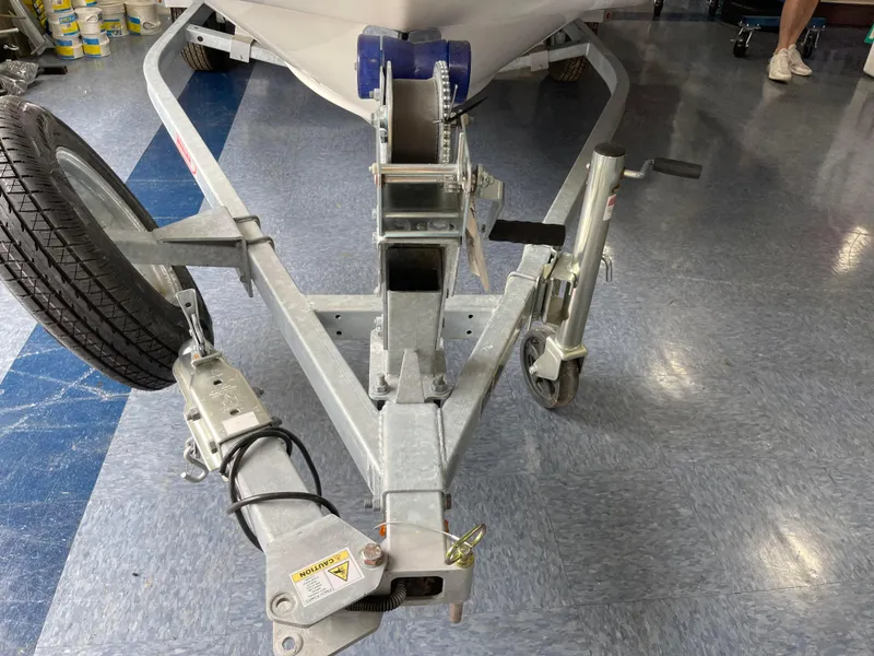 Slide: The Image of 2024 Boston Whaler 150 Montauk boat trailer in a showroom. - 14