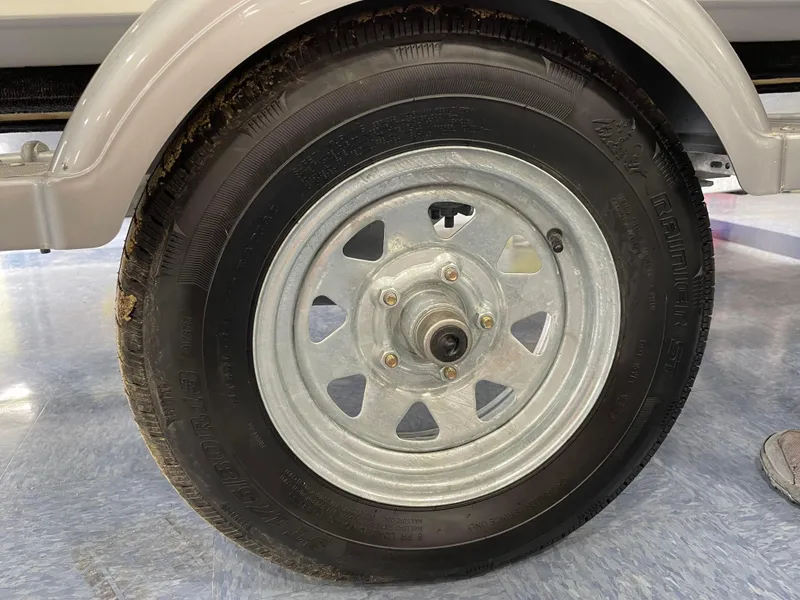 Slide: The Image of Close-up of a 2024 Boston Whaler 150 Montauk trailer wheel. - 5