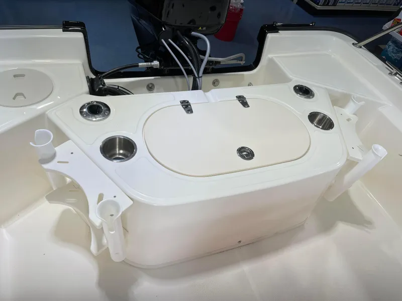 Slide: The Image of 2024 Boston Whaler 150 Montauk boat interior with storage compartment and cup holders. - 6