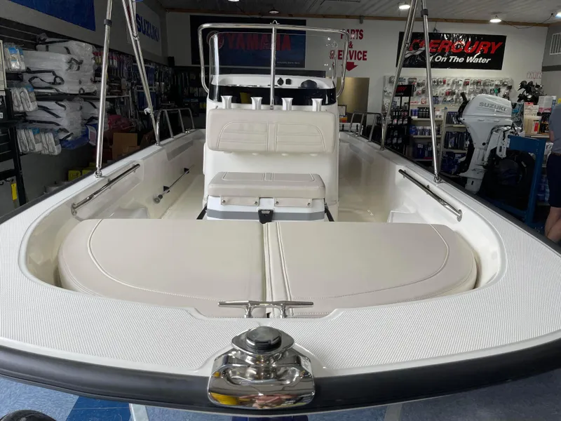 Slide: The Image of 2024 Boston Whaler 150 Montauk boat interior, showcasing seating and storage areas. - 7