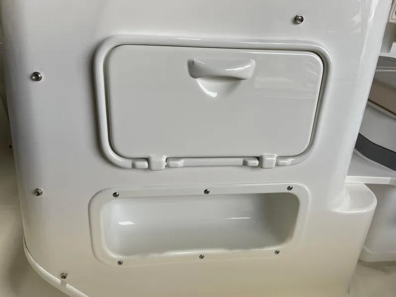 Slide: The Image of 2024 Boston Whaler 150 Montauk storage compartment and access panel. - 8