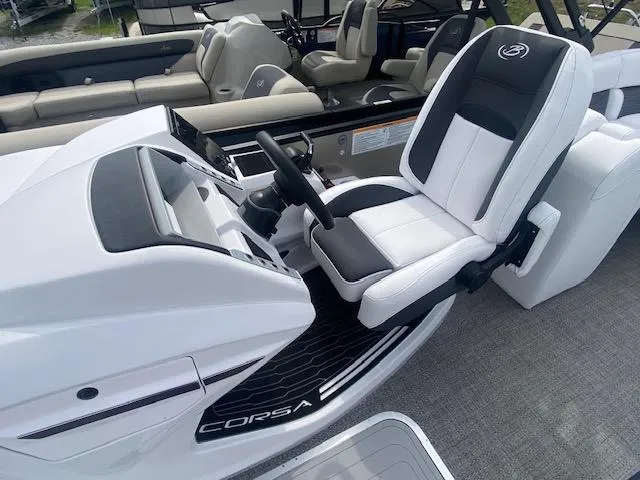 Slide: The Image of 2024 Barletta CORSA 23 QSSA boat interior with captain's chair and steering console. - 17