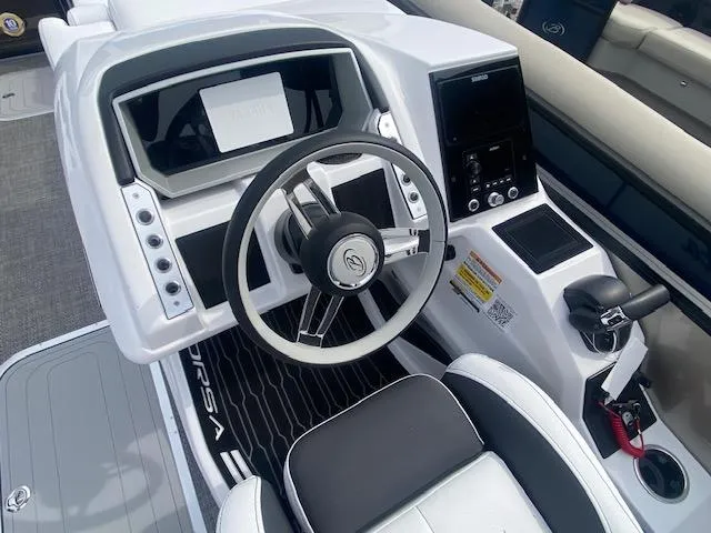 Slide: The Image of 2024 Barletta CORSA 23 QSSA boat cockpit with steering wheel and control panel. - 18