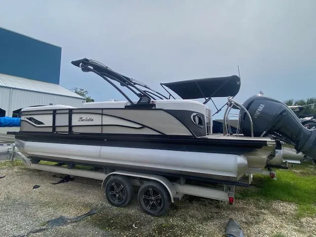 Slide: The Image of 2024 Barletta CORSA 23 QSSA pontoon boat on a trailer. - 4