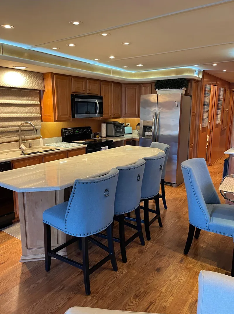 Slide: The Image of Modern kitchen interior of a 2003 Sharpe 75' Houseboat with blue bar stools. - 11