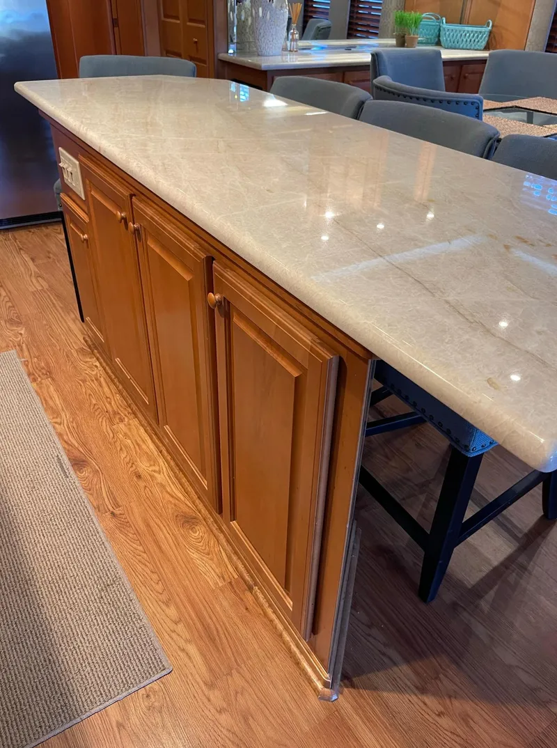 Slide: The Image of Kitchen island in 2003 Sharpe 75' Houseboat with marble countertop and wooden cabinets. - 12