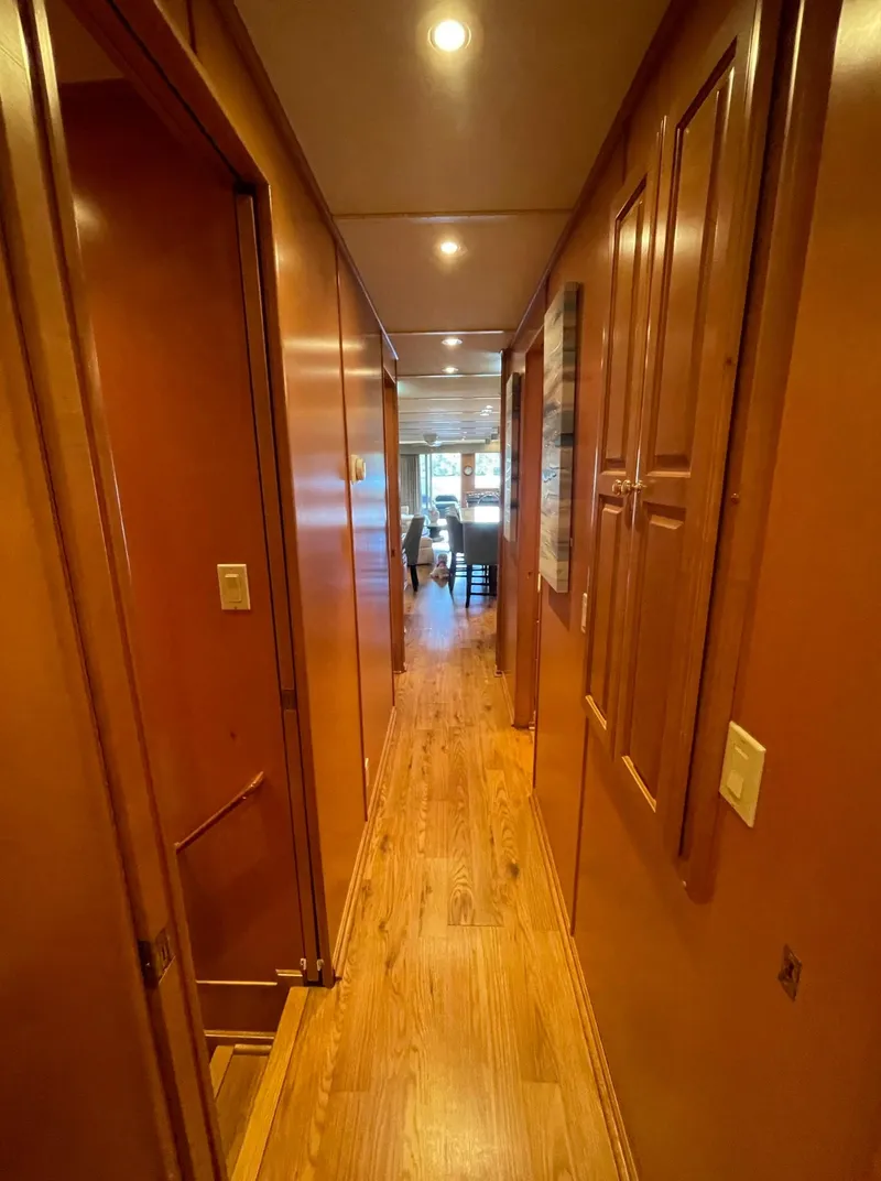 Slide: The Image of Interior hallway of a 2003 Sharpe 75' Houseboat with wooden flooring. - 14