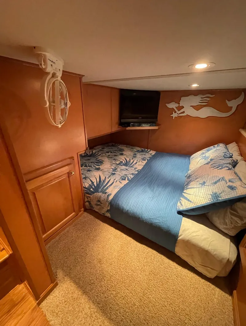 Slide: The Image of Cozy bedroom in a 2003 Sharpe 75' Houseboat with nautical decor. - 18