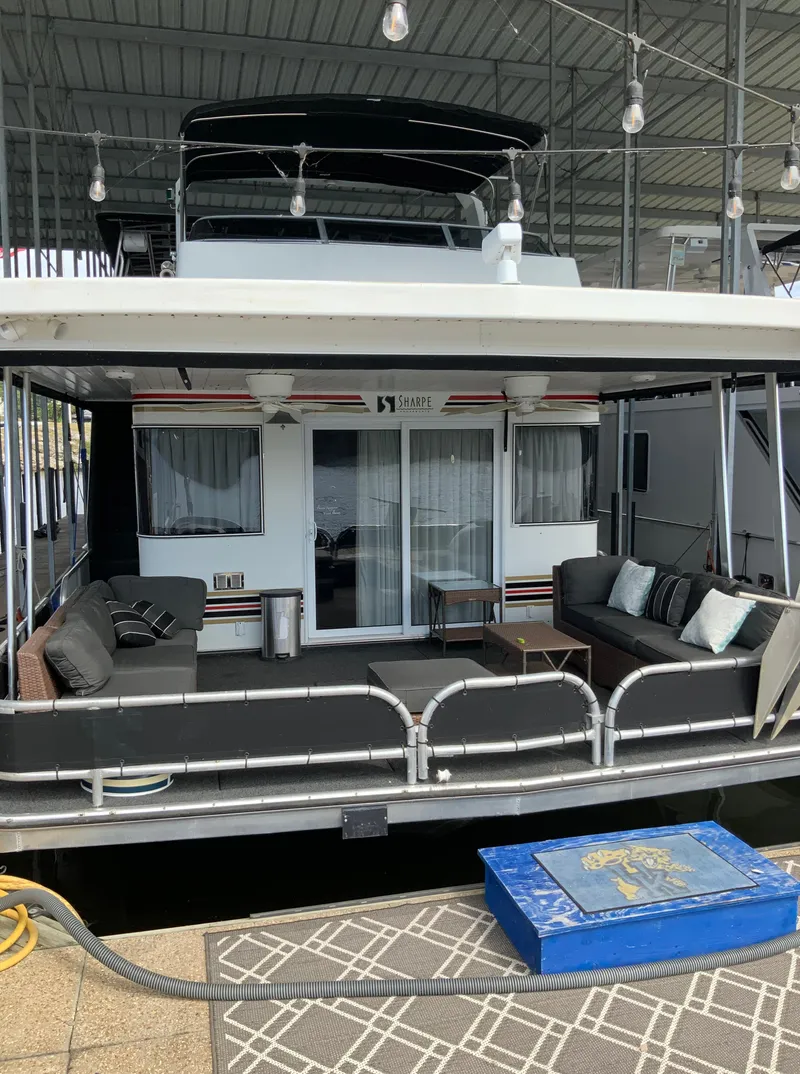 Slide: The Image of 2003 Sharpe 75' Houseboat with outdoor seating area under covered dock. - 2